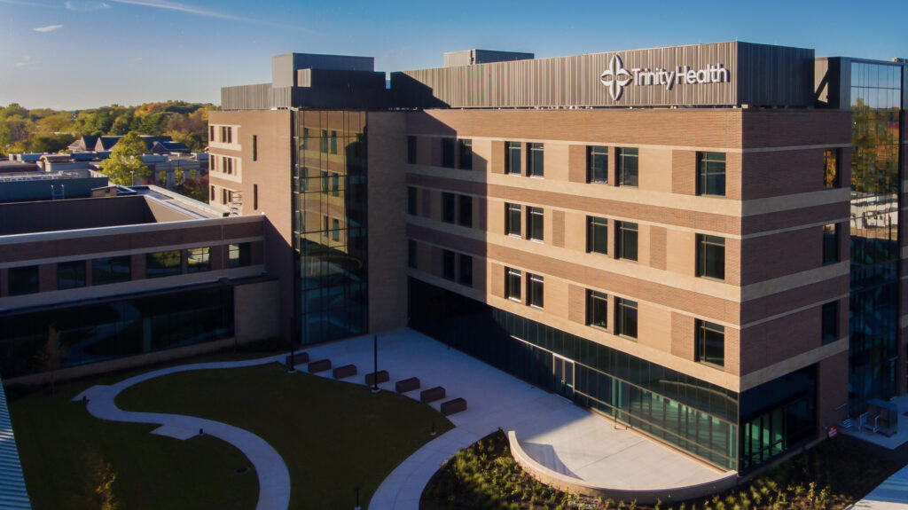 Aerial night view of the Trinity Health building in Brighton, Michigan
